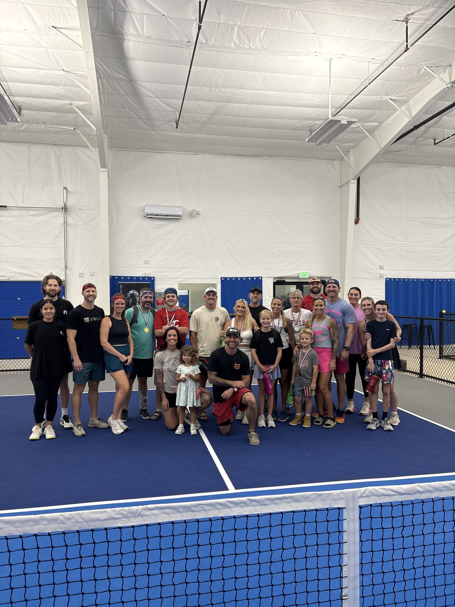 A group celebrating together on the pickleball courts at The Stack